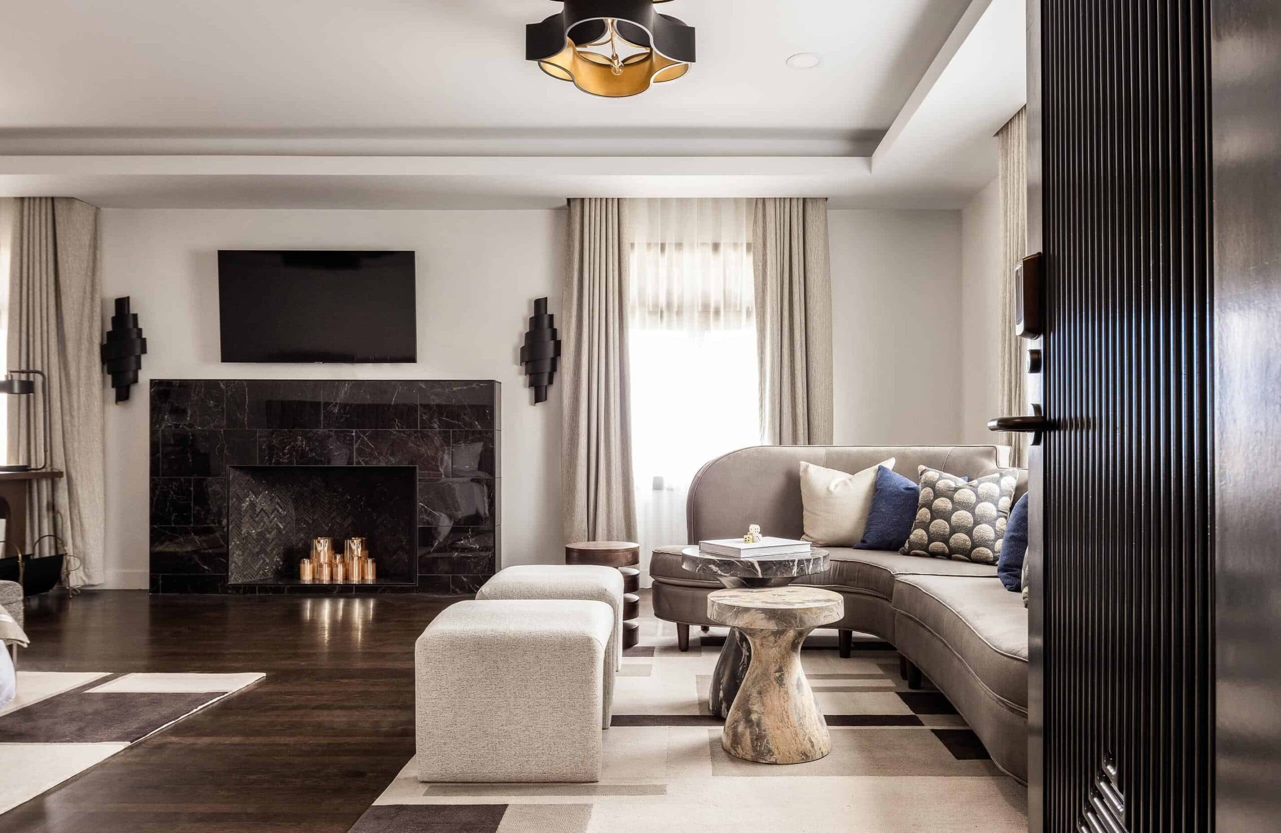 Elegant living room with a fireplace, plush seating, neutral tones, and abundant natural light.