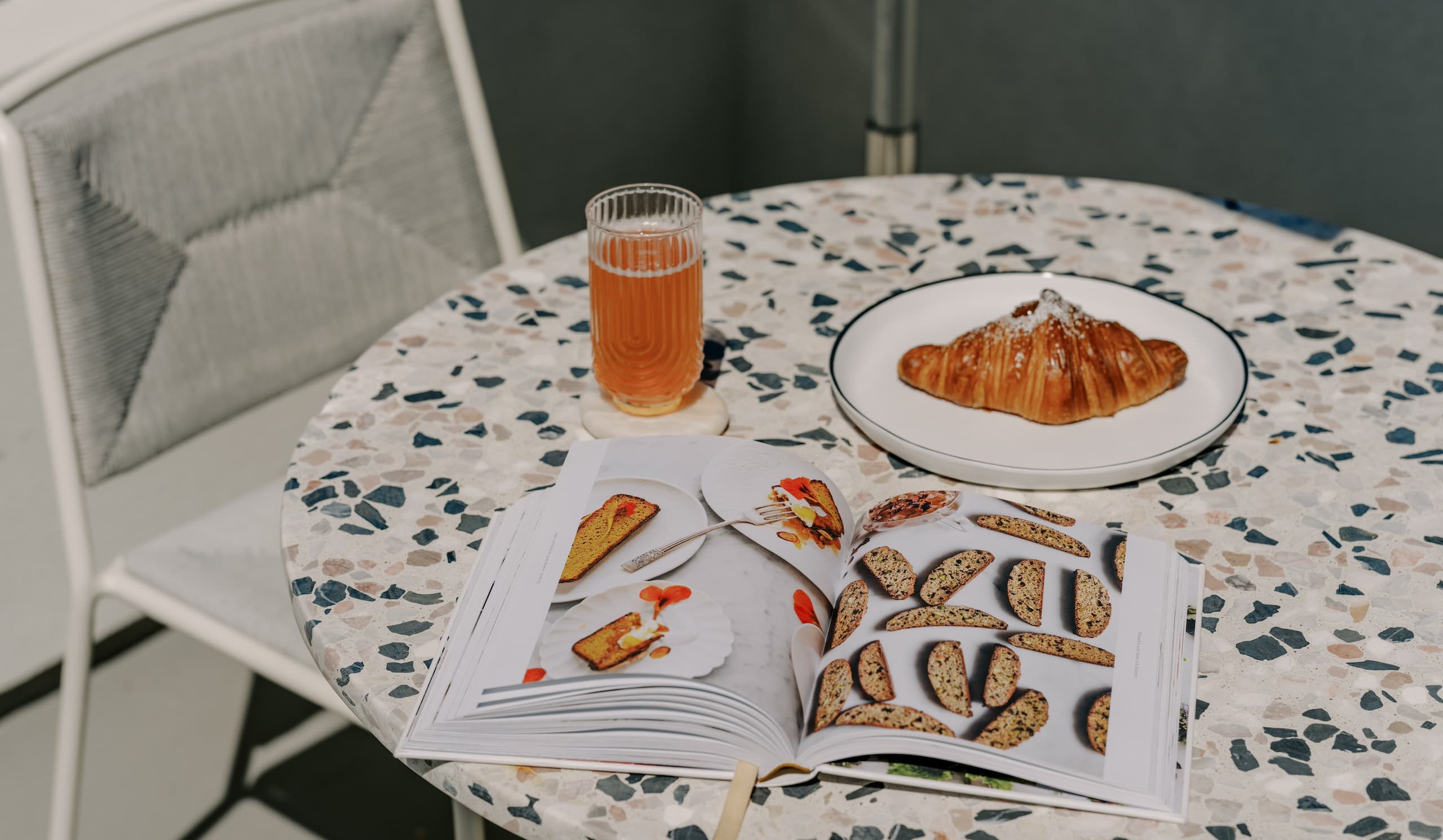 table with beverage, magazine and pastry