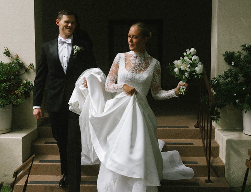 Couple walking out of Orli on their marriage day
