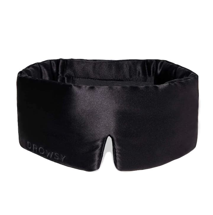 Black contoured sleep mask designed for light blocking and comfortable rest during travel or nighttime use
