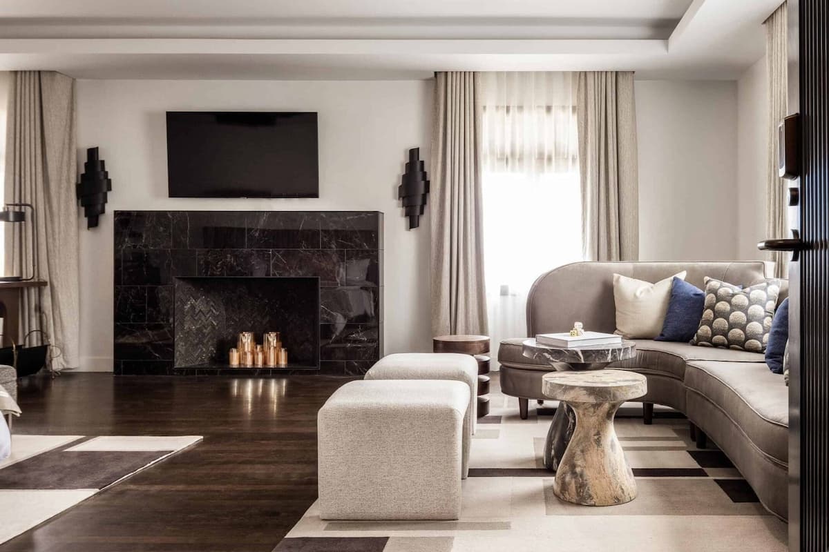 Elegant living room with modern fireplace, neutral seating, and curated décor in a luxury residential or hotel interior