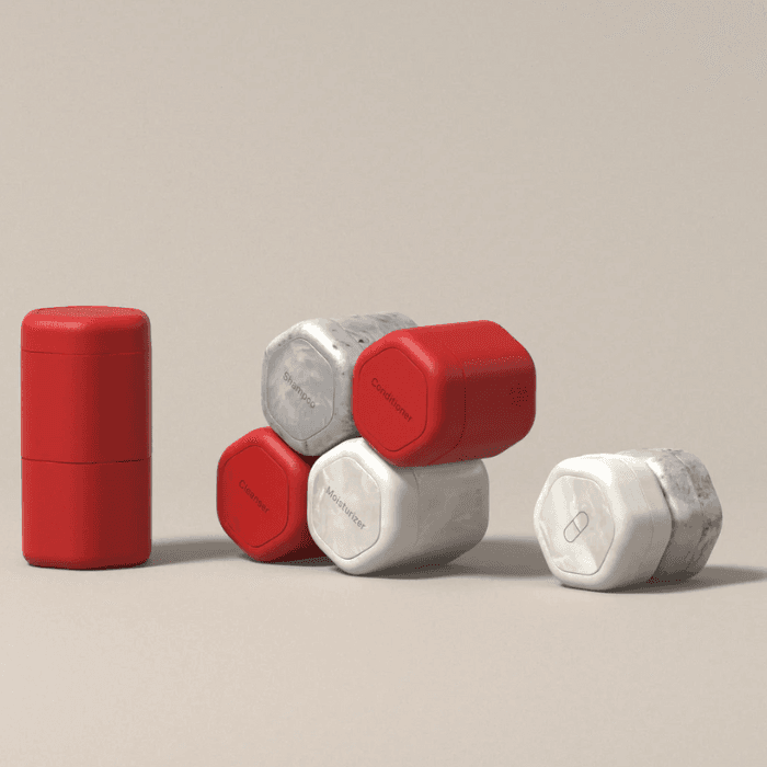 Minimalist stack of red and white reusable travel containers arranged on a neutral background for modern lifestyle storage