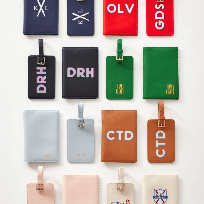 Collection of personalized leather luggage tags in assorted colors, featuring monogrammed initials and minimalist travel designs