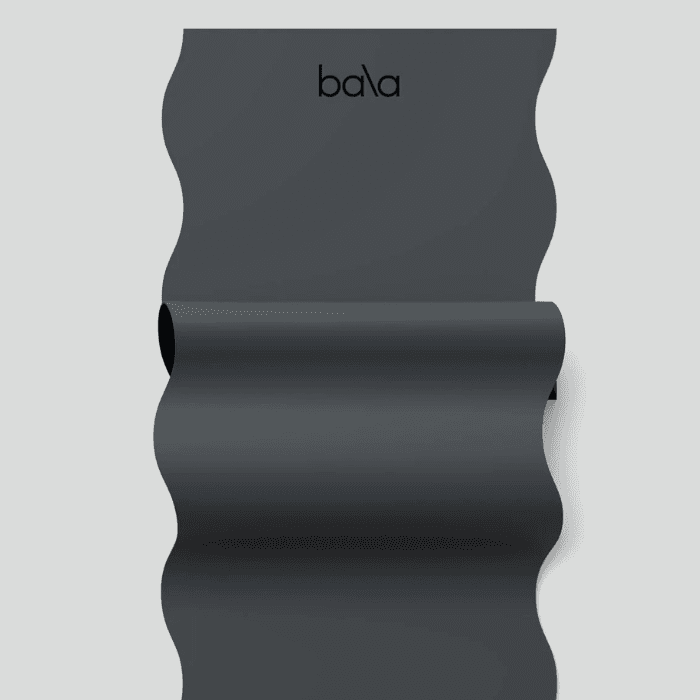 Black Bala exercise mat with wavy texture design displayed in a minimalist product presentation