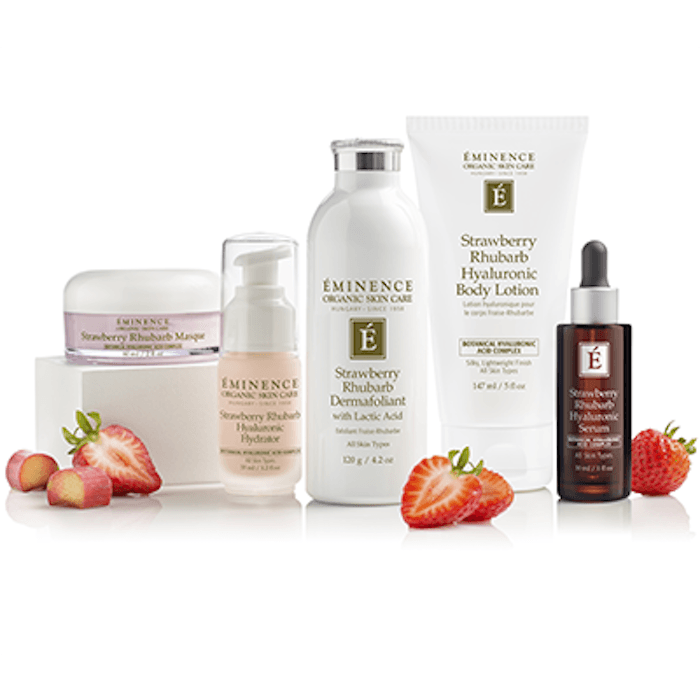 Eminence Organic Skincare strawberry rhubarb body care products displayed with fresh strawberries on a clean white background