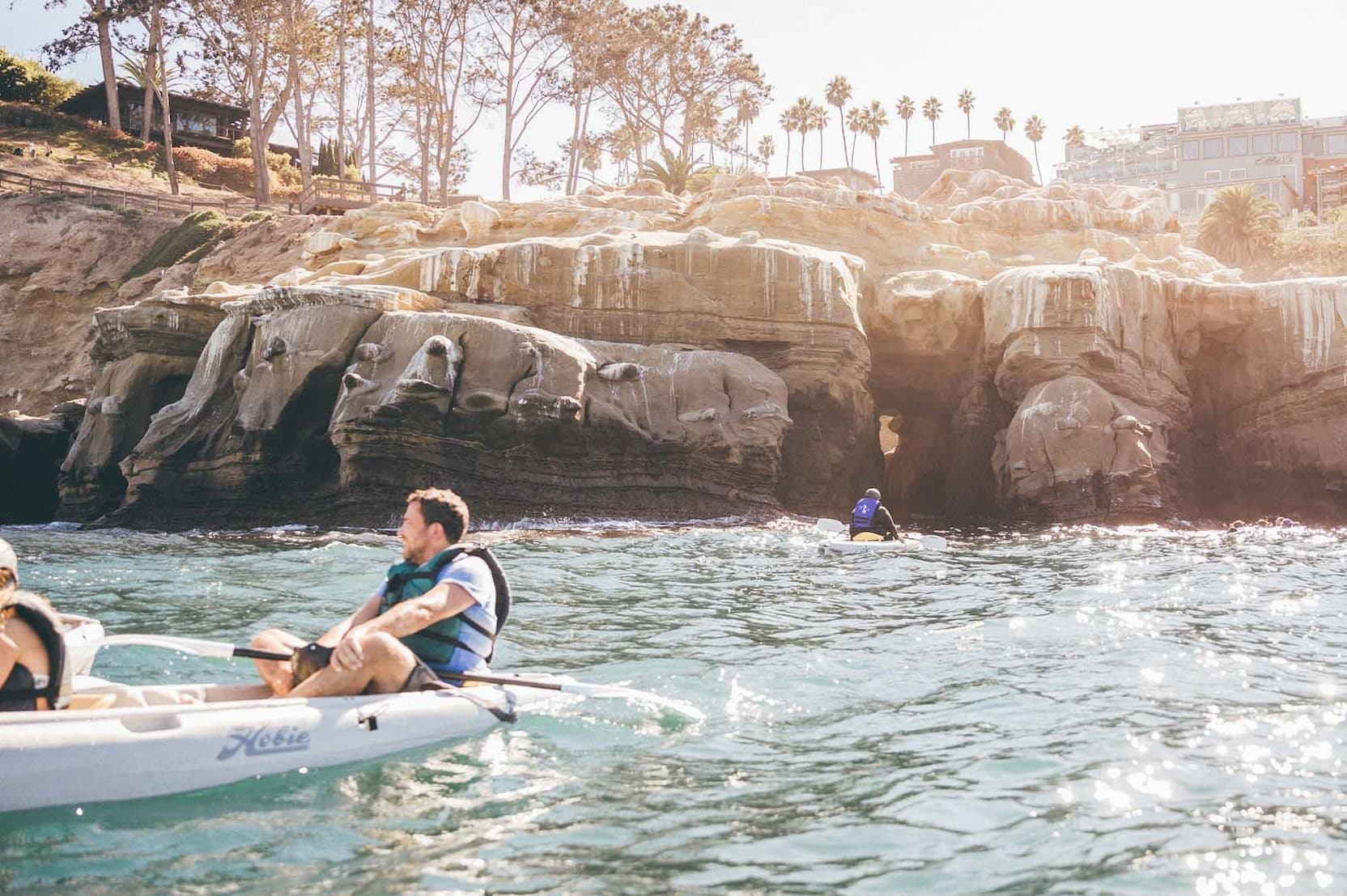 people in kayaks in the ocean